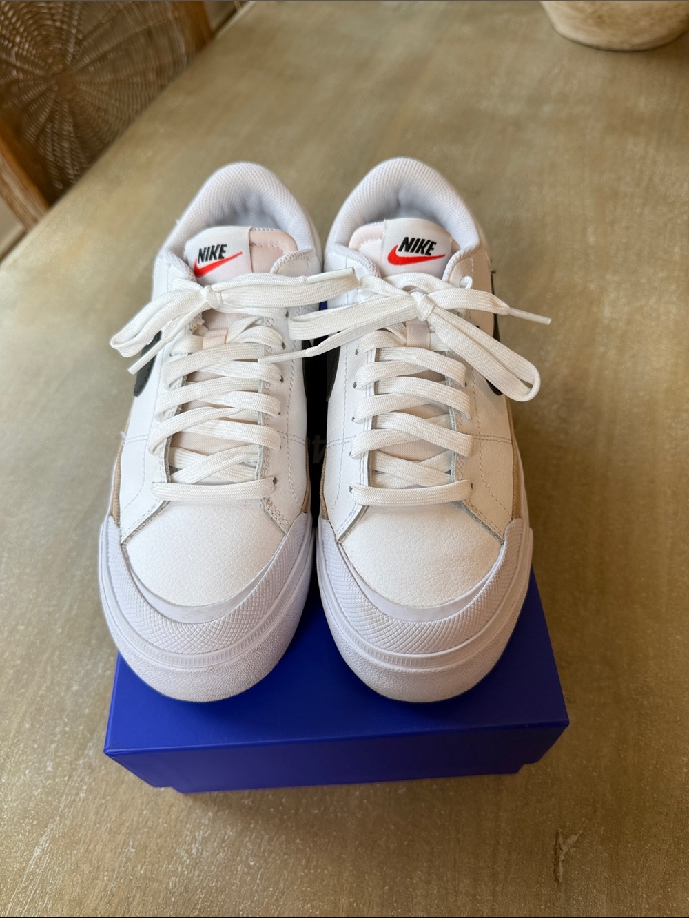 Nike White Low-Top Sneakers with Tan Stripe and Black Swoosh
